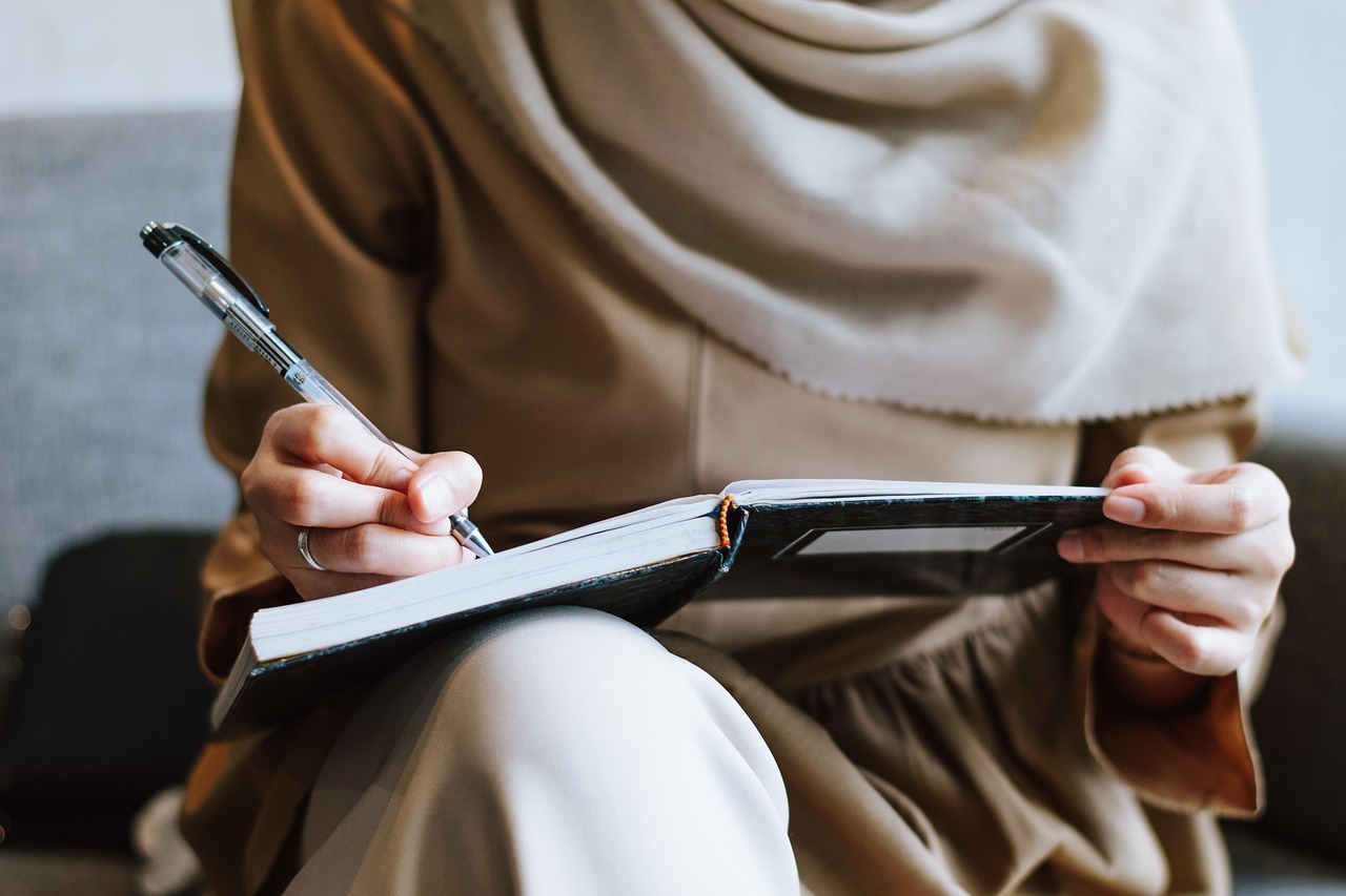 Muslim, woman, writing — Atomic Wallet: The Future of Crypto Management Awaits